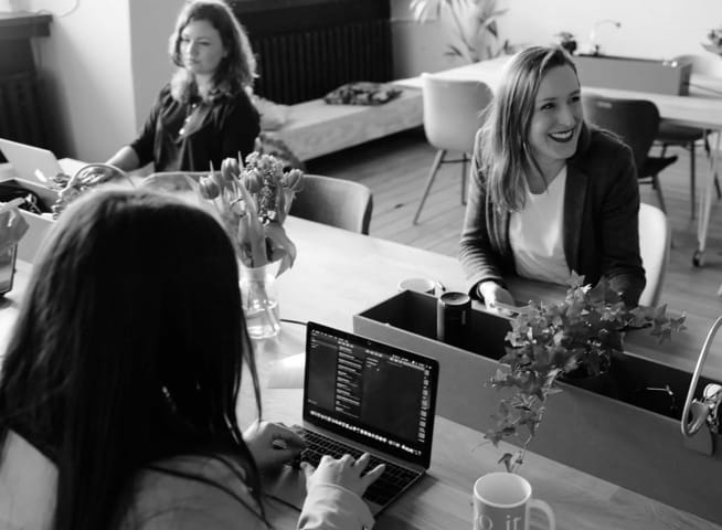 3 persons working at the computer